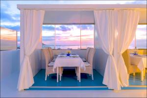 a table and chairs in a room with a window at AVANTI Lifestyle Hotel - Only Adults in Corralejo