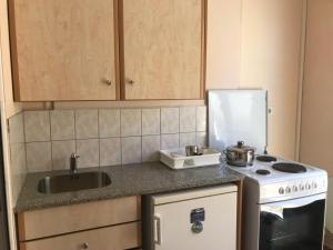a small kitchen with a sink and a stove at Natalia Studios in Poros +20 photos