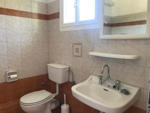 a bathroom with a toilet and a sink at Natalia Studios in Poros