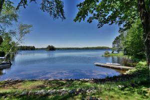 a view of a lake with a dock at Birch Bark Lodge Condo in Hayward