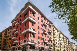a tall red building with windows on the side of it at Residenza Dorò- 24x7 Check-in in Rome