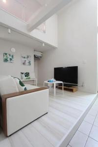a living room with a couch and a flat screen tv at Building A101 / Vacation STAY 1274 in Tokyo