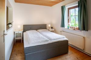 a bed in a bedroom with a window at Lakeview Apartment in Hallstatt