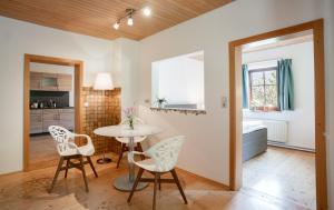 a kitchen and dining room with a table and chairs at Lakeview Apartment in Hallstatt