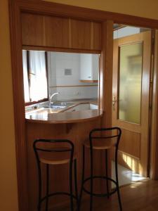 Kuchyň nebo kuchyňský kout v ubytování Apartamentos Turisticos Puerta de León