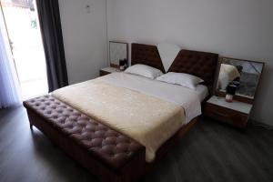 a bedroom with a large bed and a large window at Kings Apartment 4 in Kolgecaj