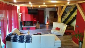 a living room with a white couch and a fireplace at Chalet les Vagnys - Lac des Vernays in La Rivière-Enverse