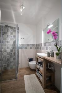 a bathroom with a sink and a glass shower at Apartman Villa Katrina in Mošćenička Draga
