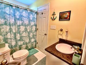 a bathroom with a toilet and a sink at Mi Casa Del Mar Home in Caplen +18 photos