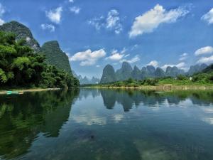 a view of a river with mountains in the background at Yangshuo Yunshe Mountain Guesthouse in Yangshuo