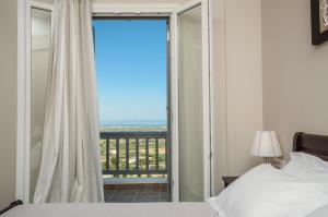 a bedroom with a bed and a window with a view at Villa Natalia in Glinado Naxos