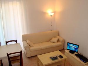 a living room with a couch and a table at Alba Blu in Santa Caterina Dello Ionio Marina