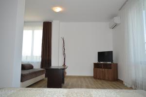 a living room with a couch and a tv at SummerHouse Lozenets in Lozenets