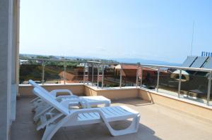 two chairs and a bench on a balcony at SummerHouse Lozenets in Lozenets