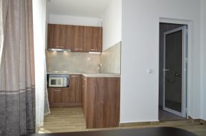 a kitchen with wooden cabinets and a microwave at SummerHouse Lozenets in Lozenets +19 photos