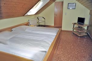 En eller flere senge i et værelse på Hotel Tannenhof