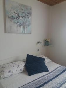 a bedroom with a bed with a painting on the wall at Apartment Nono Ivo in Vis