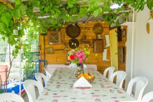 a table with a vase of flowers on it at Ideal Studios in Amoudara Herakliou