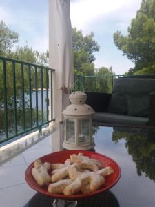 a plate of food on a table with a lantern at Apartment Nono Ivo in Vis