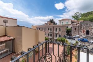 a balcony with a view of a city at Theokles Apartment in Taormina