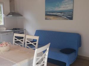 a kitchen with a table and a blue table and chairs at Apartment Nono Ivo in Vis
