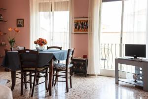 a dining room with a table and chairs and a window at Theokles Apartment in Taormina