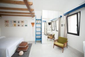 a bedroom with a bed and a chair and a ladder at House Koloc in Bol