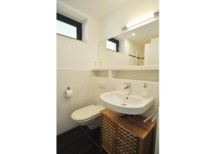 a bathroom with a sink and a toilet at Ferienwohnung Moselufer Zell in Zell an der Mosel +20 photos