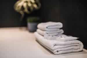 a pile of towels sitting on a table at Maestro Design Hotel in Liepāja