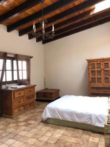 ein Schlafzimmer mit einem Bett und einer Holzdecke in der Unterkunft Ocean Front Antique House, Private Beach! in Rosarito