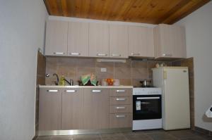 a kitchen with white cabinets and a refrigerator at Villa Marija in Ohrid