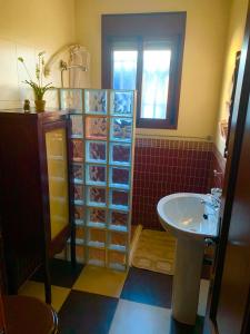 a bathroom with a sink and a toilet and a sink at LOS ROSALES in Alcaracejos