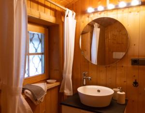 a bathroom with a sink and a mirror at Bauernhaus Spathen in Santa Valburga St. Walburg +48 photos