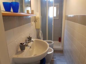 a bathroom with a sink and a toilet at Sweet Apartment Bianchini in Bologna +21 photos