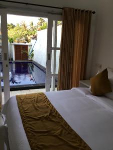 a bedroom with a bed and a view of a pool at Queen Guest house tulamben in Tulamben +29 photos