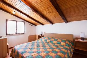 a bedroom with a bed in a room with wooden ceilings at Apartment Armando in Poreč