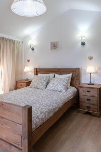 a bedroom with a wooden bed with two night stands at Casa dos Cortes in Sever do Vouga