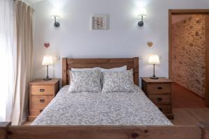 a bedroom with a large bed with two night stands at Casa dos Cortes in Sever do Vouga
