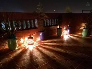 a group of lights on a tile floor with potted plants at Marrakech Family appartements in Marrakesh