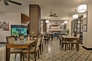 a dining room with tables and chairs in a restaurant at Haka Boutique Hotel in Danang