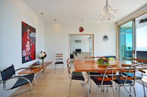 a dining room with a wooden table and chairs at Aporo Nelson Holiday Home in Nelson