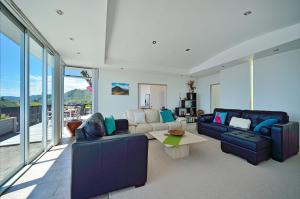 a living room with a couch and a table at Aporo Nelson Holiday Home in Nelson