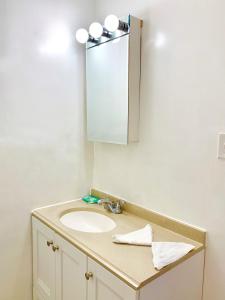 a bathroom with a sink and a mirror at White Caps Motel in North Wildwood