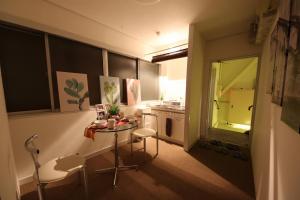 a small kitchen with a small table and a window at Casa HANA in Tokyo