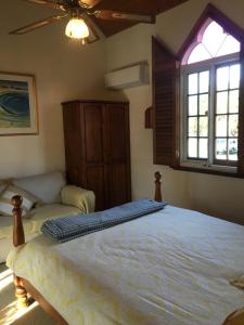 a bedroom with a large bed and a window at RoseMoore Bed & Breakfast in Perth