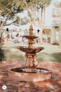 a fountain in a park with people sitting in the background at Dubuque Bed and Breakfast in Numurkah