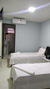 a hospital room with two beds and a sink at Pousada Bela Vista in Guabiraba