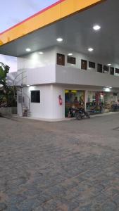 a gas station with a motorcycle parked outside of it at Pousada Bela Vista in Guabiraba