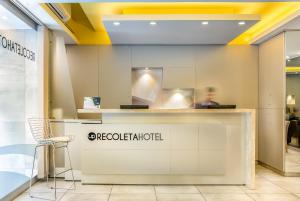 a counter in a store with a person in the background at Up Recoleta Hotel in Buenos Aires