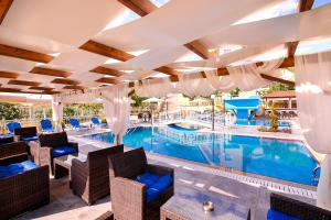 a pool at a resort with chairs and a swimming pool at Hotel Diamond in Limenaria